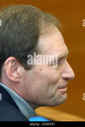 (dpa) - 42-year-old German computer specialist Armin Meiwes bites his lips during his trial at the district court in Kassel, Germany, 23 January 2004. The murder trial of the self-declared cannibal continues on its twelfth day. At the beginning of the trial Meiwes has admitted killing and eating his victim but denies murder. With cannibalism itself not illegal under German law, Mei Stock Photo