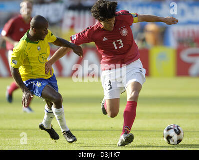 (dpa) - German soccer player Michael Ballack (R) fights for the ball with Brazilian midfielder Ze Roberto during the semi-final of FIFA Confederations Cup tournament Germany vs. Brazil in Nuremberg, Germany, 25 June 2005. Stock Photo