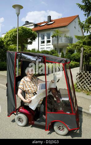 (dpa files) - The 83-year-old Margarethe Strobel working as a house-sitter drives from house to house in her electric cart, in Welzheim, Germany, 3 June 2003. She sits the homes of people who are on holidays or work abroad. Her duties include feeding the pets, emptying the letter box and watering the flowers. Stock Photo