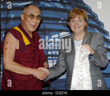 (dpa) - The Dalai Lama turns the traditional white 'peace shawl' over to the Chairperson of the German conservative party, Angela Merkel, in Berlin, 17 June 2005. Tibet's spiritual leader visits Germany for a couple of days. Stock Photo