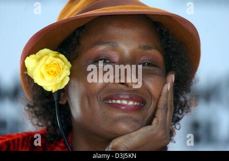 (dpa) - Smiling and with a yellow rose in her hair listens UN special ambassador and Somalian model Waris Dirie to questions from journalists during a press conference in Hamburg, Germany, 8 June 2004. During a gala on Wednesday evening, 9 June 2004, the Women's World Award will be awarded for the first time to a group of outstanding females. Among the women to receive awards are B Stock Photo