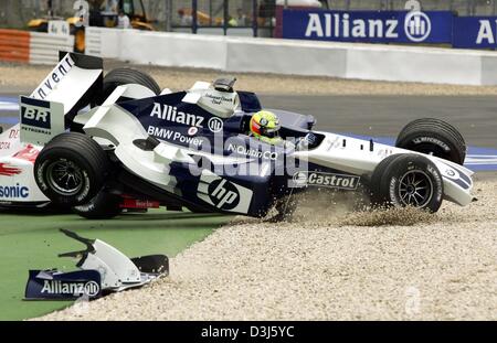 (dpa) - German formula one pilot Ralf Schumacher (BMW-Williams) collides with Brazil's Christiano da Matta (covered) in the first bend during the European Grand Prix at the Nuerburgring race track in Germany, 30 May 2004. Stock Photo