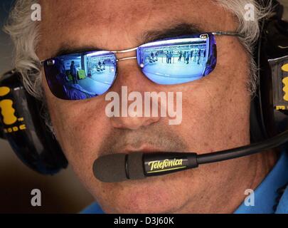 (dpa) - Renault team leader Flavio Briatore wears a pair of mirrored sunglasses and a set of headphones at the Nuerburgring race track in Germany, 28 May 2004. The European Grand Prix took place at the Nuerburgring on 30 May 2004. Stock Photo