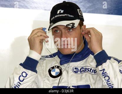 (dpa) - German formula one pilot Ralf Schumacher of BMW-Williams takes out his earphones during the free training at the Nuerburgring race track in Germany, Friday 28 May 2004. The European Grand Prix takes place at the Nuerburgring on 30 May 2004. Stock Photo