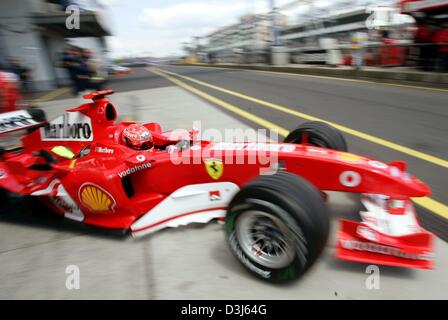 (dpa) - German formula one champion Michael Schumacher leaves the pit area in his Ferrari racing car during the second free training at the Nuerburgring race track in Germany, Friday, 28 May 2004. Schumacher drove the ninth fastest time. The European Grand Prix takes place at the Nuerburgring on 30 June 2004. Stock Photo