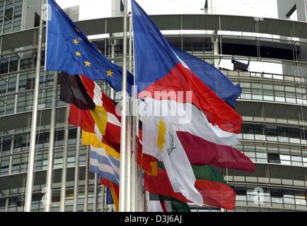 (dpa) - The flags of the new members of the European Union (R, Czech Republic in front) flutter next to the flags of the old EU members (L, European flag in front) in front of the European Parliament in Strasbourg, France, 3 May 2004.