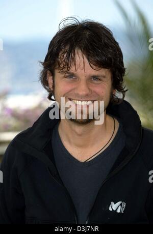 (dpa) - Austrian film director Hans Weingartner smiles as he poses during the 57th Cannes Film Festival in Cannes, France, 17 May 2004. Weingartner promoted his new film 'Die fetten Jahre sind vorbei' (the fat years are over) which is also the first German language film in eleven years to participate in the festival. Stock Photo