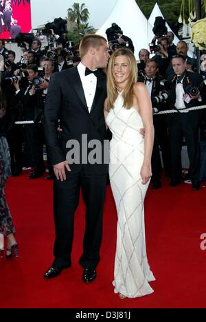 (dpa) - Hollywood star Brad Pitt whispers into the ear of his wife Jennifer Aniston upon their arrival at the presentation of Pitt's new movie 'Troy' at the 57th Film Festival in Cannes, France, 13 May 2004. In the movie Pitt stars as Greek hero Achilles. Stock Photo