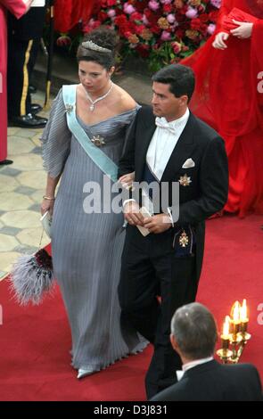 (dpa) - Princess Alexia of Greece and her husband Carlos Morales walk on the red carpet as they leave the cathedrale after the wedding ceremony of Danish crown prince Frederik and Mary Donaldson in Copenhagen, Denmark, Friday, 14 May 2004. Members of all European royal dynasties were among the 800 invited guests who attended the wedding. Stock Photo