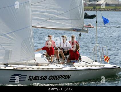 (dpa) - Crown prince Frederik of Denmark (C) sails with his crew during a sailing regatta in the harbour of Copenhagen, Denmark, 9 May 2004. Frederik and Mary Donaldson, his finacee, were competing with each other in a sailing regatta which was eventually won by Mary. Stock Photo