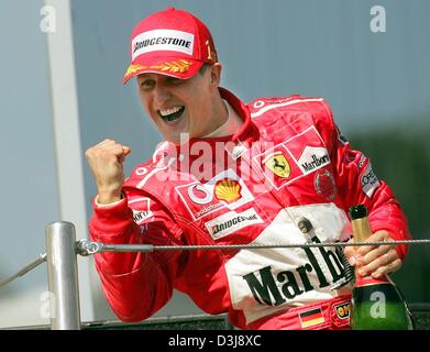 (dpa) - German formula one pilot and world champion Michael Schumacher (Ferrari) jubilates after winning the San Marino grand prix in Imola, Italy, 25 April 2004. Stock Photo