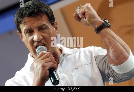 (dpa) - US actor Sylvester Stallone presents the products of his new fitness and health company Instone at the FIBO sport fair in Essen, Germany, 24 April 2004. The Hollywood star said he considered making a fourth 'Rambo' movie. Stallone was quoted as saying at the fair that he felt a little too old to play Rocky, but he would like to make another Rambo film. The first Rambo film  Stock Photo