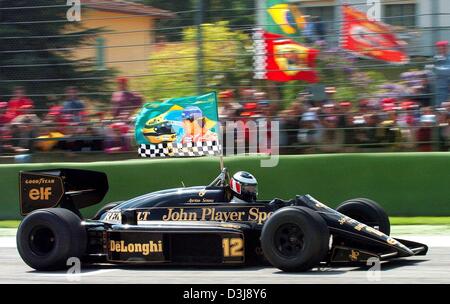 (dpa) - With a flag of the late Formula One world champion Ayrton Senna, retired Austrian pilot Gerhard Berger drives a lap of honour in Senna's legendary Lotus-Renault car at the 'Enzo und Dino Ferrari' circuit  prior to the San Marino Grand Prix in Imola, Italy, 25 April 2004. Berger drove three laps of honour in the 1986 Lotus Renault in memory of Senna, who was killed on this r