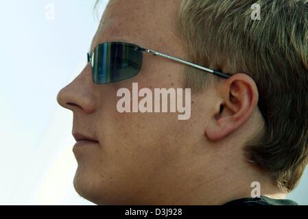 (dpa) - Finnish formula one pilot Kimi Raeikkoenen (McLaren Mercedes),wears a pair of sunglasses at the 'Enzo e Dino Ferrari' racing circuit in Imola, Italy, 22 April 2004. The San Marino grand prix starts on Sunday 25 April 2004. Stock Photo