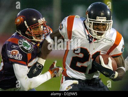 NFL Europe League Championship Final World Super Bowl Frankfurt Galaxy  Adesola Badon holds off Rhein Fire defence at the Hampden Park stadium in  Glasgow Stock Photo - Alamy