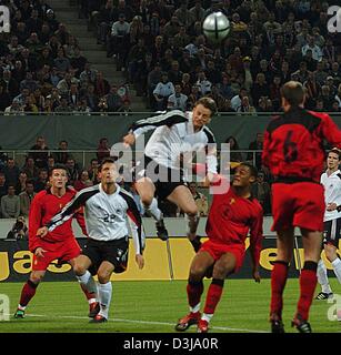 (dpa) The German player Christian Woerns (middle) is fighting for the ball with Belgian player Vincent Kompany (4), the German player Kevin Kuranyi (2nd left) looks on during the friendly soccer match between Germany and Belgium in Cologne on Wednesday, 31 March 2004. The German national soccer team won their second test match this year 3:0. Stock Photo