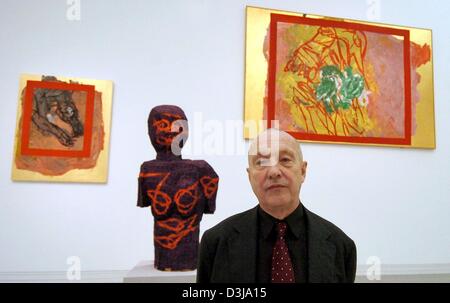 (dpa) - German artist Georg Baselitz stands in front of two paintings and his sculpture 'Ding mit Asien' (thing with Asia) which is made out of Ayous (African hardwood), cloth and oil paint at the Bundeskunsthalle (federal art hall) in Bonn, Germany, 31 March 2004. The retrospective which will be held at the art hall from 2 April until 8 August 2004, titled 'Pictures That Turn Your Stock Photo