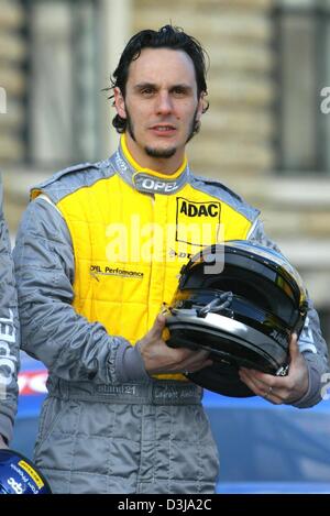 (dpa) Laurent Aiello, French driver for the Opel team in the German Touring Car Championship (DTM) holds his helmet during the DTM presentation in front of the Hamburg city hall on Tuesday, 30 March 2004. Two and a half weeks away from the first race at the Hockenheim racetrack the DTM drivers presented themselves and their cars to the public.