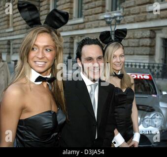 (dpa) Laurent Aiello, French driver for the Opel team in the German Touring Car Championship (DTM) arrives with two bunnies, provided by his sponsor, for the DTM gala in the Hamburg city hall on Monday, 29 March 2004. Two and a half weeks away from the first race at the Hockenheim racetrack the DTM drivers presented themselves and their cars to the public.
