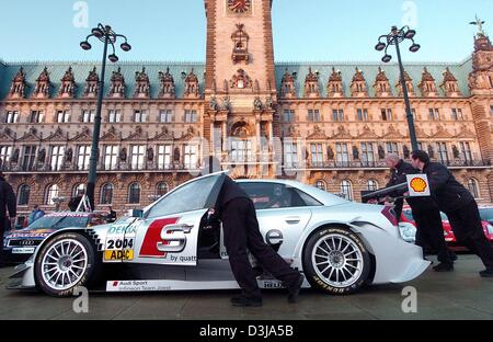 (dpa) Employees of the German Touring Car Championship (DTM) push a Mercedes touring car in front of the Hamburg city hall on Tuesday, 30 March 2004. Two and a half weeks away from the first race at the Hockenheim racetrack the DTM drivers presented themselves and their cars to the public.