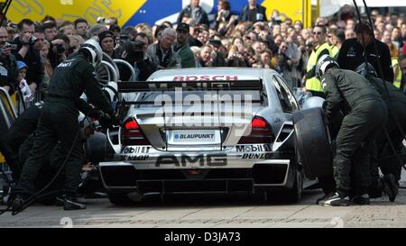 (dpa) Mercedes mechanics demonstrate a pit stop in front of spectators at the German Touring Car Championship (DTM) presentation in front of the Hamburg city hall on Tuesday, 30 March 2004. Two and a half weeks away from the first race at the Hockenheim racetrack the DTM drivers presented themselves and their cars to the public.