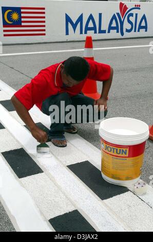 (dpa) A Malaysian navvy paints the last racetrack markers on the Sepang racetrack near Kuala Lumpur on Wednesday, 17 March 2004. On Sunday, 21 March 2004, the Grand Prix of Malaysia will underway. Stock Photo