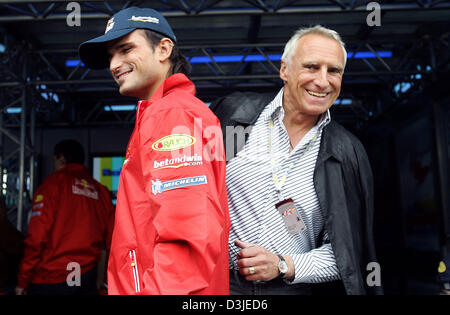 (dpa) - Owner of Red Bull company and Red Bull Racing Team, Austrian billionaire Dietrich Mateschitz (R) and his Italian Formula One driver Vitantonio Liuzzi joke in the paddock at the F1 race track in Imola, Italy, 23 April 2005. The Grand Prix of San Marino took place 24 April. Stock Photo