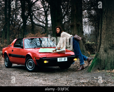 Young woman with her Fiat X1/9 sports car 1983 Stock Photo