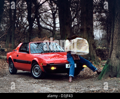 Young woman with her Fiat X1/9 sports car 1983 Stock Photo