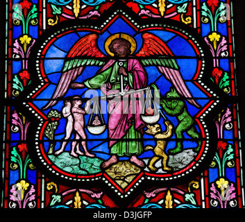 Stained glass window depicting Saint Michael the Archangel at the Final Judgement, in Bayeux, Calvados, France Stock Photo