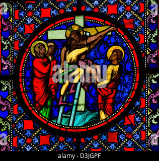 Stained Glass window depicting Jesus taken from the cross. Stock Photo