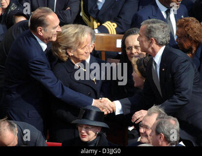 (dpa) - French President Jacques Chirac (L) and US President George W. Bush greet each other, while Chirac's wife Bernadette stands next to Chirac, at the start of the funeral service for Pope John Paul II at Saint Peter's Square in the Vatican, Vatican City State, 8 April 2005. The Pope died at the age of 84 last Saturday. Stock Photo