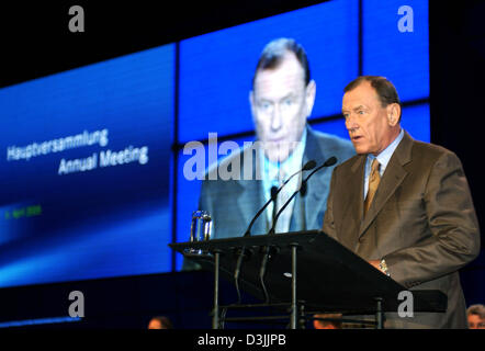 (dpa) - Juergen Schrempp, Chairman of DaimlerChrysler, stands in front of large video screen as he speaks to shareholders during the annual shareholders meeting in Berlin, Wednesday, 06 April 2005. Several funds companies refuse to release Schrempp from his responsibilities concerning the company's business results. Criticism is also expected to come from many small shareholders. Stock Photo