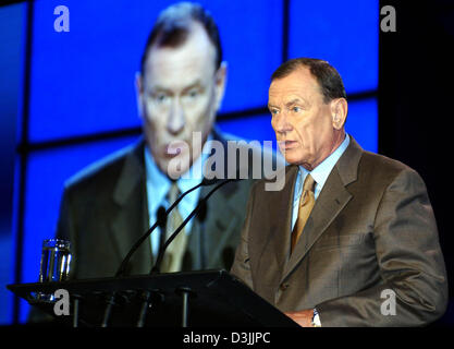 (dpa) - Juergen Schrempp, Chairman of DaimlerChrysler, stands in front of large video screen as he speaks to shareholders during the annual shareholders meeting in Berlin, Wednesday, 06 April 2005. Several funds companies refuse to release Schrempp from his responsibilities concerning the company's business results. Criticism is also expected to come from many small shareholders. Stock Photo