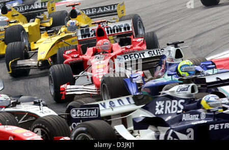 (dpa) - German Formula One driver Michael Schumacher (Ferrari) in action after the start of the Grand Prix of Malaysia in Sepang, near Kuala Lumpur, Malaysia, 20 March 2005. Schumacher finished 7th. Stock Photo