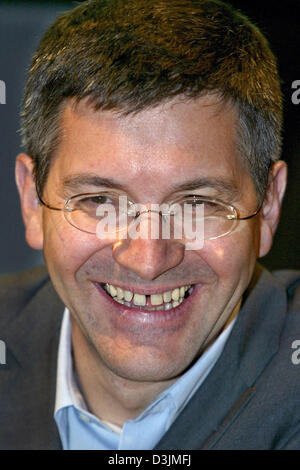 (dpa) - Herbert Hainer, Chairman of Adidas-Salomon AG, smiles during  the balance press conference at the company's headquarter in Herzogenaurach, Germany, Wednesday, 09 March 2005. After record earnings of 314 million euros the previous year, the company expects to increase the results by 15 to 20 percent. Stock Photo