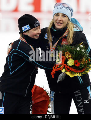 (dpa) - German speed skater Anni Friesinger (R) celebrates with second place finisher Claudia Pechstein after winning the Women's 5000 meter race at the Speed Skating World Championship in Inzell, Germany, 6 March 2005. Stock Photo