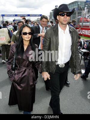 (dpa) - US-born actor Nicolas Cage and his third wife, former waitress Alice Kim, walk over the starting grid before the Grand Prix of Australia, Sunday 06 March 2005 in Melbourne, Australia. Giancarlo Fisichella of Italy won in front of Rubens Barrichello of Brazil and Fernando Alonso of Spain. Stock Photo