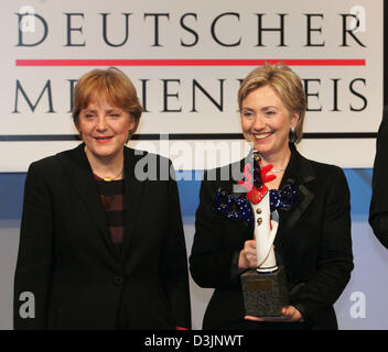(dpa) - US Senator Hillary Clinton smiles as she stands next to Angela Merkel (L), Chairwoman of the CDU, after receiving the German Media Prize 2004 in Baden-Baden, Germany, 13 February 2005. Clinton was awarded the prize for her exemplary engagement advancing the role of women in the world of politics, society and media. Stock Photo