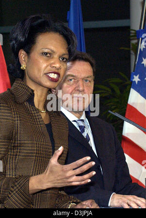 (dpa) - German Chancellor Gerhard Schroeder (R) listens intently to US Secretary of State Condoleezza Rice as she speaks during a press conference after their meeting in Berlin, 04 February 2005. Their meeting was concerned with relief aid for the reconstruction of Iraq and Iran's nuclear policy. Stock Photo