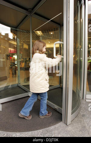 (dpa) - A little girl walks through the revolving door of a department store in Cologne, Germany, 10 January 2004. Stock Photo