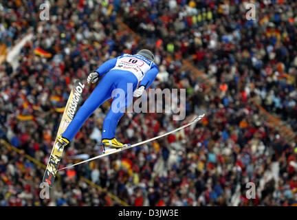 (dpa) - German ski jumper Michael Uhrmann jumps in front of a large crowd in the third leg of the 53rd International Four Hills Tournament in Innsbruck, Austria, Monday 3 January 2005. Stock Photo