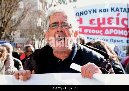 Thessaloniki, Greece. 20th February 2013. A demonstrator holding a banner while shouting during a general strike on 20/02/2013 in Thessaloniki, Greece. The strike was called by the trade union confederations of GSEE and ADEDY. Protesters were demonstrating against the austerity measures in Greece which has seen taxes increased and wages, pensions and public spending cut.  Credit:  Art of Focus / Alamy Live News Stock Photo