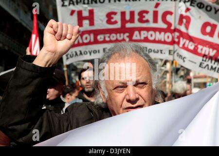 Thessaloniki, Greece. 20th February 2013. A demonstrator holding a banner during a general strike on 20/02/2013 in Thessaloniki, Greece. The strike was called by the trade union confederations of GSEE and ADEDY. Protesters were demonstrating against the austerity measures in Greece which has seen taxes increased and wages, pensions and public spending cut.  Credit:  Art of Focus / Alamy Live News Stock Photo