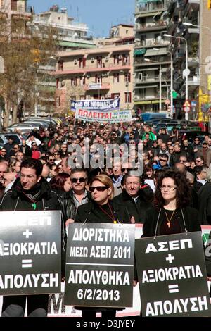 Thessaloniki, Greece. 20th February 2013. Demonstrators holding banners march through the street during a general strike on 20/02/2013 in Thessaloniki, Greece. The strike was called by the trade union confederations of GSEE and ADEDY. Protesters were demonstrating against the austerity measures in Greece which has seen taxes increased and wages, pensions and public spending cut.  Credit:  Art of Focus / Alamy Live News Stock Photo