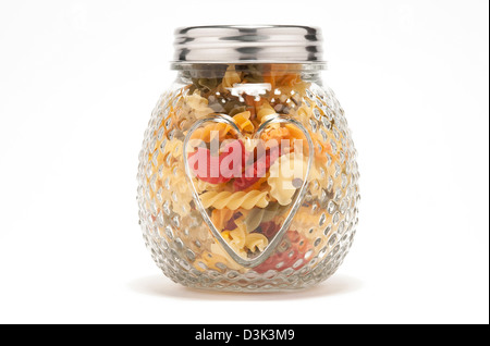colourful pasta in glass heart shaped jar Stock Photo