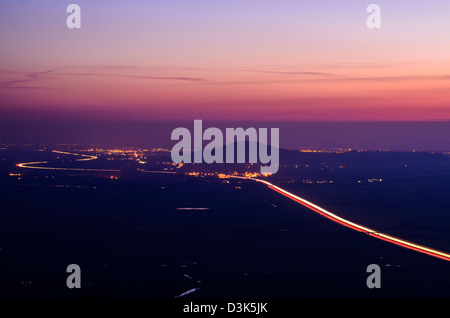 Brent Knoll and the M5 motorway viewed from the Mendip Hills at dusk, Somerset, England. Stock Photo