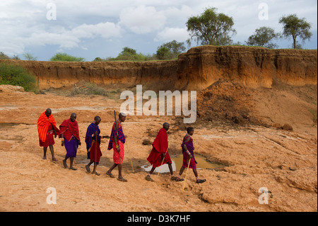 Maasai walking in a river bed, Selenkay Conservancy, Kenya Stock Photo