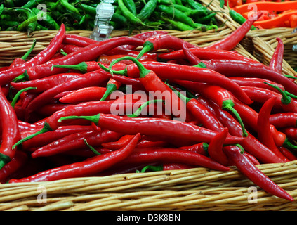 a basket of red chillies on a market Stock Photo