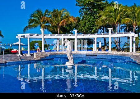 Negril JamaicaSwimming pool with bright reflections and classical statue at Hotel Riu Palace Tropical Bay all-inclusive resort, Stock Photo